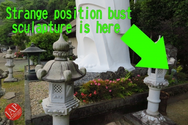 strange-position-serious-bust-sculpture-at-the-foot-of-strange-position-buddha-statue0010